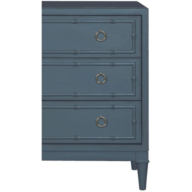 This beautifully detailed piece features carved bamboo details, turned legs, brushed nickel ring pulls and three drawers....