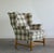 A classic camelback wingback with flat scrolled wings, softly rolled arms, and a loose boxed seat cushion. What sets it...
