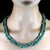 Two 34-inch infinity-style emerald chip necklaces create a striking, effortless look that feels both natural and...