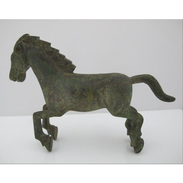 Small vintage bronze replica of a Han Dynasty galloping Horse figure featuring a green patina. Excellent condition. Very...