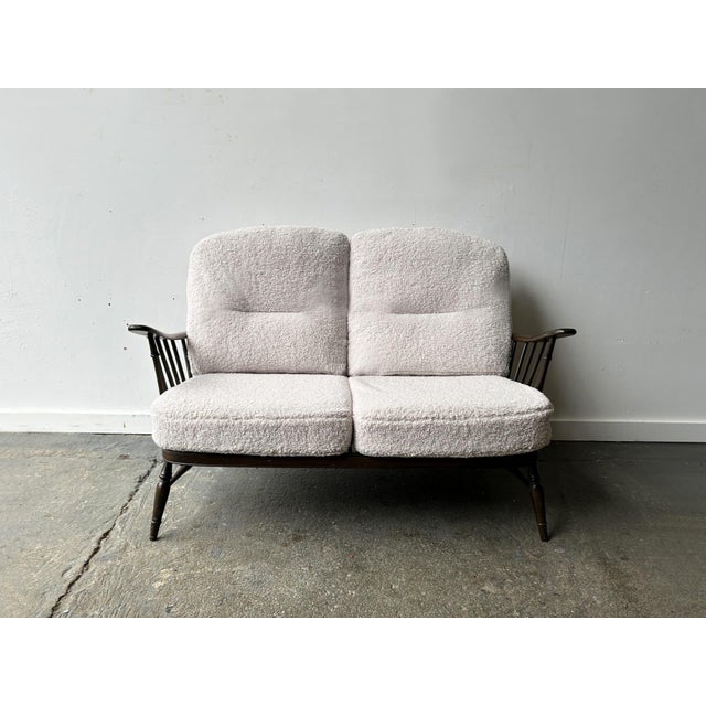 A mid-century vintage 1950s-60s Ercol Windsor2 seat sofa designed by Lucian Ercolani – Ercol’s founder and designer. The...