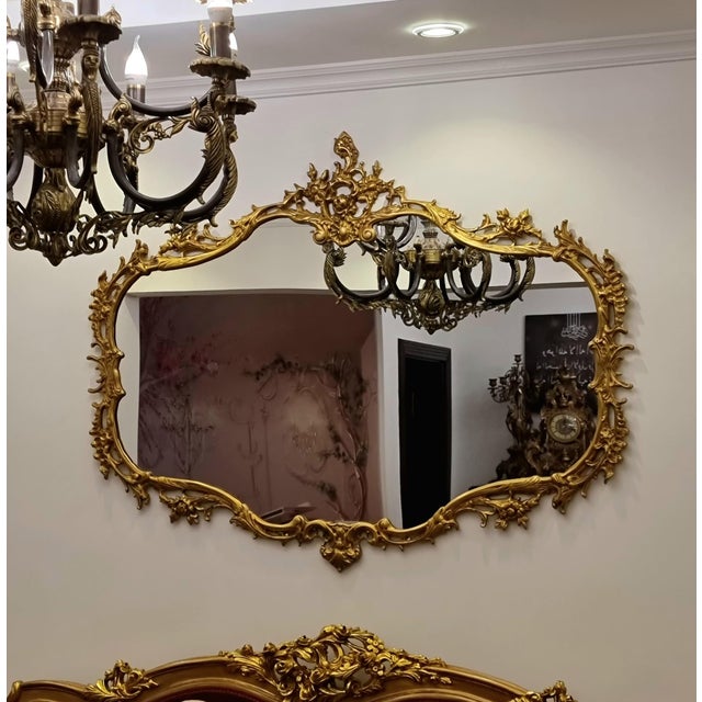 Make a statement with this elegant French Rococo-inspired wall mirror, featuring a beautifully sculpted frame with...