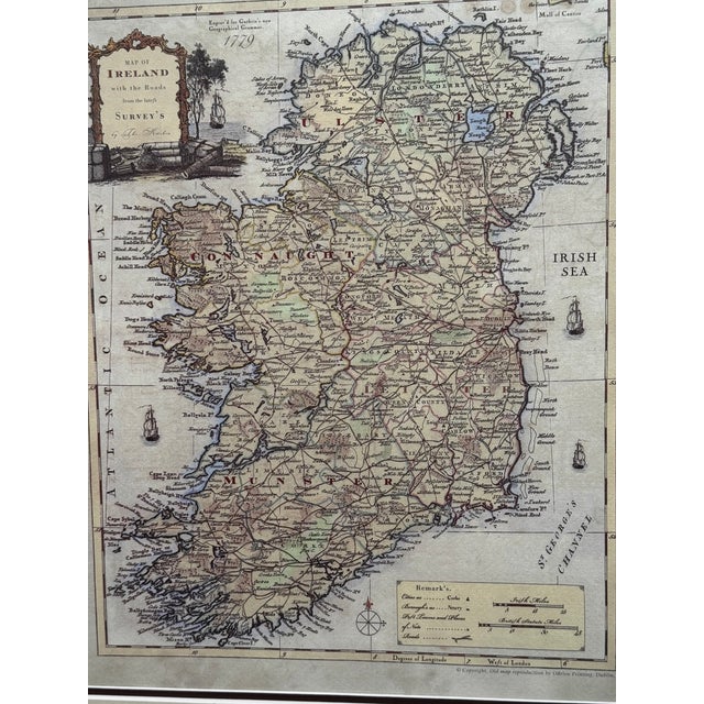 Decorative reproduction of a detailed 1779 map of Ireland, handsomely presented in a dark wood frame with layered cream...