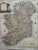 Decorative reproduction of a detailed 1779 map of Ireland, handsomely presented in a dark wood frame with layered cream...