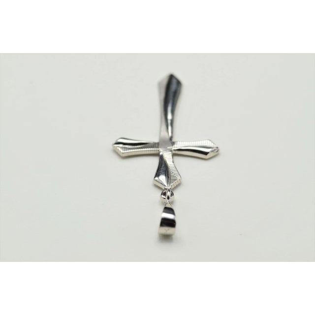 1.25 Inch 14K White Gold Cross Pendant. This pendant measures 1.25 inches without the bail and is stamped SARO 14K on the...