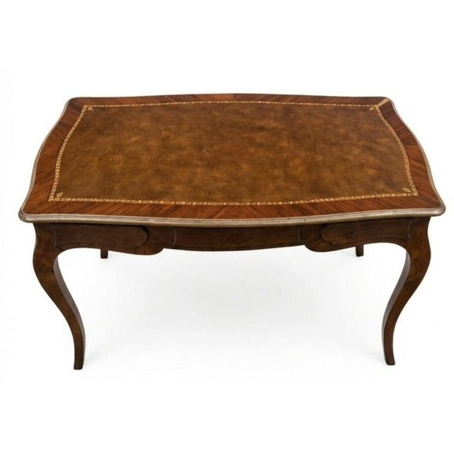 This is a French Louis XV-style bureau plat (flat-top writing desk) featuring a leather-insets top, shaped serpentine...