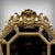 Elegant octagonal mirror with beveled glass in the Louis XV style. Made of stuccoed and gilded wood, the frame is richly...