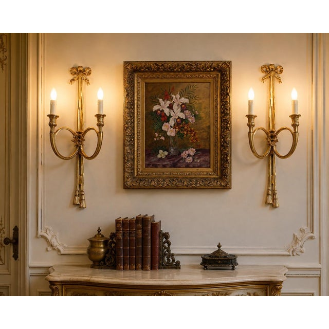 This elegant pair of late 20th-century French wall sconces reflects the refined symmetry and classical ornamentation of...