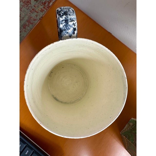 Add a touch of cheerful folk-art charm to your space with this delightful antique spongeware ceramic can or mug....