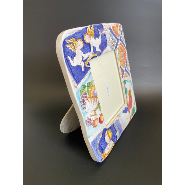 A 1994 Vietri photo frame beautifully blends a captivating mix of various Italian scenes and motifs, including cherubs, a...