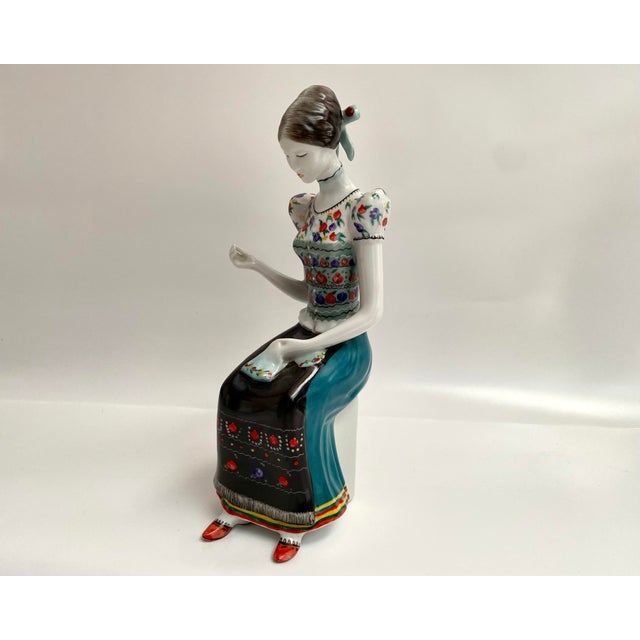 Vintage Hollohaza Porcelain Figurine "Embroiderer" - Hand-Painted Hungarian Collectible from the 1970s-1980s Add a touch...
