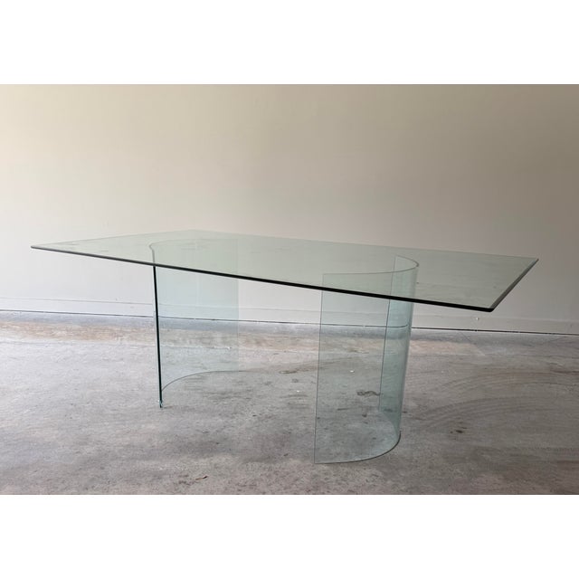 exceptional vintage sculptural glass dining table featuring a substantial and very heavy rectangular beveled glass top...