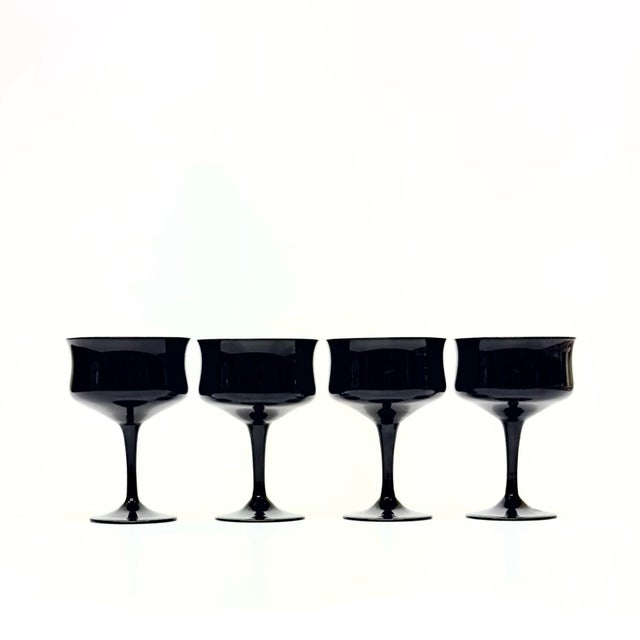 Black champagne coupe, set of 4. A beautiful set of black fluted champagne coupes from the mid-20th century. When you...