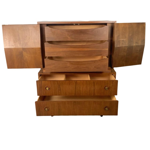 Capturing the architectural rhythm of post-war American design, this exceptional mid-century modern highboy gentleman's...