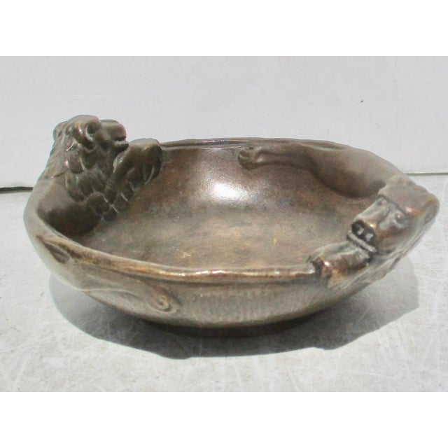 Heavy dark bronze bowl by Otto Meyers. Thick weighty bronze with two lions chasing each other and catching the tail of the...