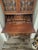 Antique secretary has 2 cabinet doors on top the doors have rounded glass in them. 4 drawers on the bottom. with a pull...