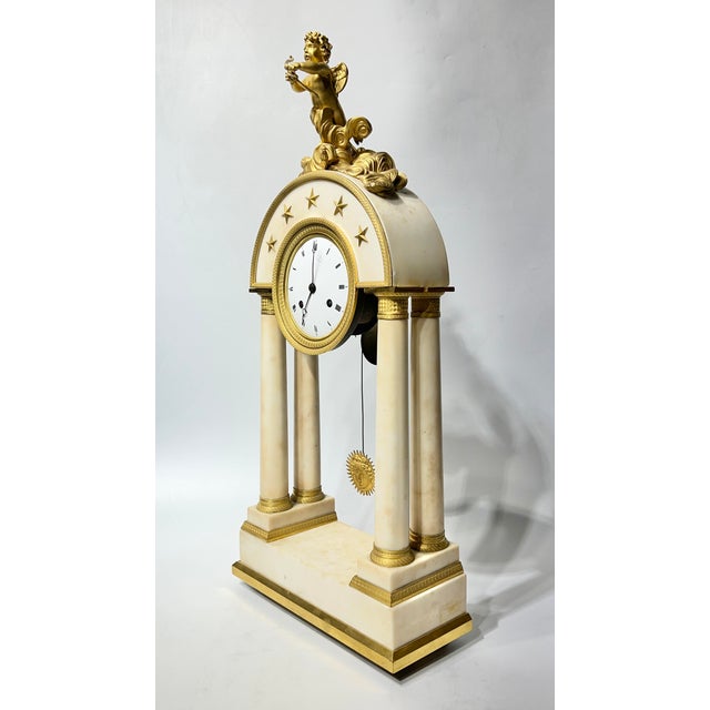 Beautiful antique (19th century) French portico form mantel clock in white marble with finely cast ormolu bronze mounts,...