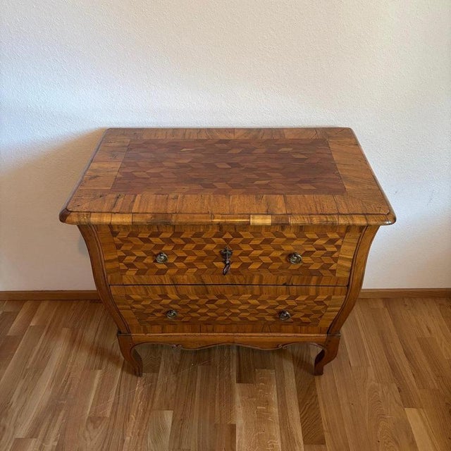 – wonderful diamond marquetry – unique shape | one of a kind – impressive presence dimensions: w: 84cm h: 77cm d: 54cm...