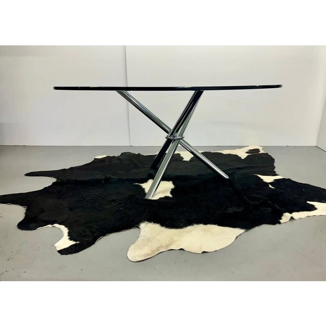 Striking mid century modern round dining or conference table having cool chrome tripod base that folds and 3/4” thick...