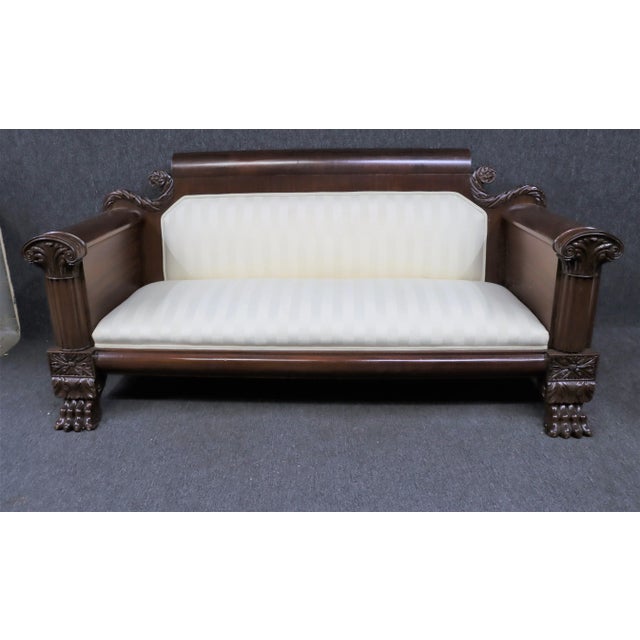 American Classical Empire Sofa , 19th Century, made of solid mahogany and flame mahogany veneer , detailed acanthus carved...