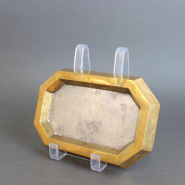 An aluminium and brass vide-poche (circa 1980s) by David Marshall, is weighty for its size and wonderfully tactile with...