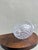 A delightful clear glass pineapple candle holder with a finely textured diamond-faceted body catching and refracting light...