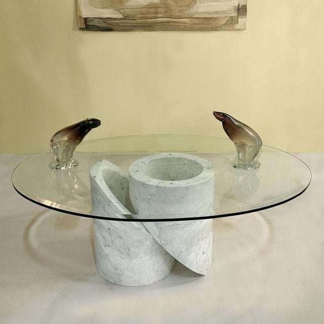 Sculptural Carrara marble coffee table with oval glass top, Italy 1960's. The base consists of two interlinked cylinders...