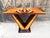 An Art Deco console table typically features the streamlined elegance and geometric motifs characteristic of the Art Deco...
