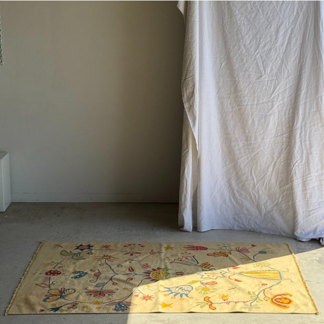 Large beige Indian rug with floral motifs. Beautiful figurative designs of animals and plants. Warm symbolism....