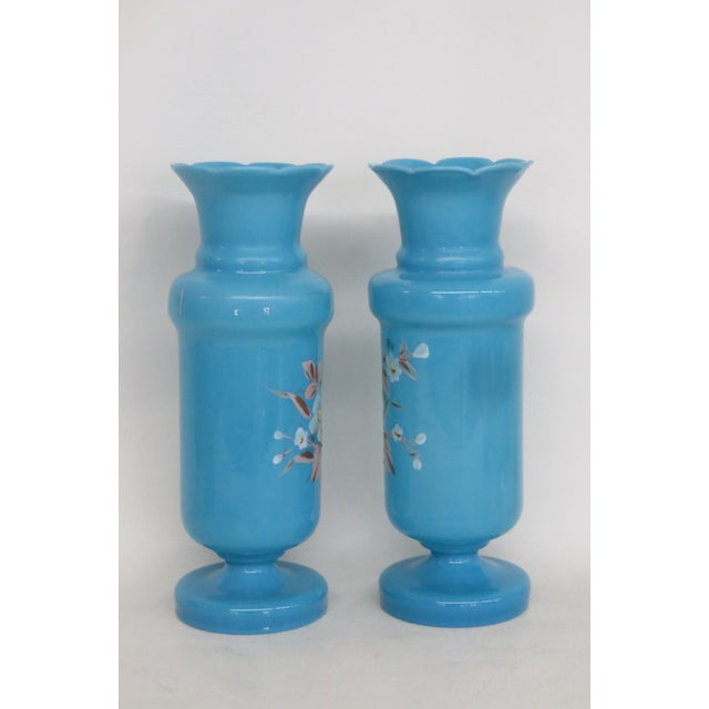 This gorgeous Pair of 2 Vases are made of glass. These lovely vases a present a gorgeous turquoise blue color throughout...