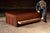 Large-format industrial flat file cabinet constructed in hardwood with a broad plank top and a bank of wide, shallow...