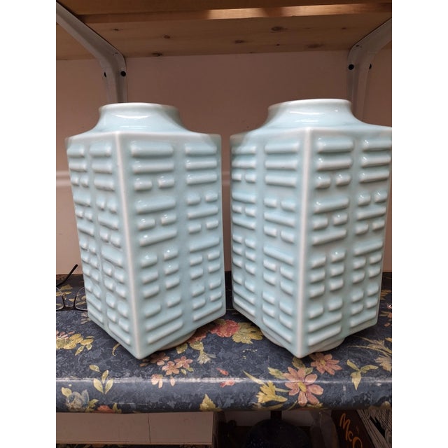 A magnificent pair of antique Chinese porcelain Cong-form vases, featuring a lustrous, smooth pale green celadon glaze....