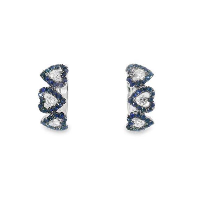 Fabulous 18K white gold heart-shaped huggie earrings featuring numerous natural round sapphires totaling 0.5 carats and...