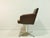 This vintage swivel chair is an authentic design piece from the 1970s, distinguished by its clean mid-century design and...