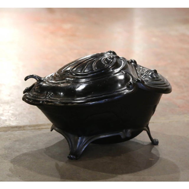This antique coal scuttle was created in France, circa 1870. Built of cast iron, and shaped as a shell with foliage...