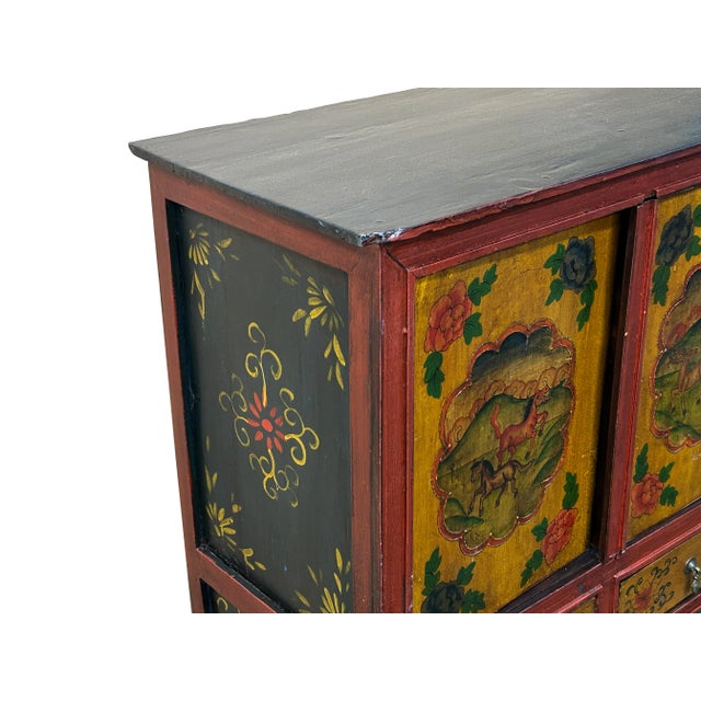 Elevate your home decor with this stunning hand-painted Tibetan cabinet, a perfect blend of cultural artistry and...