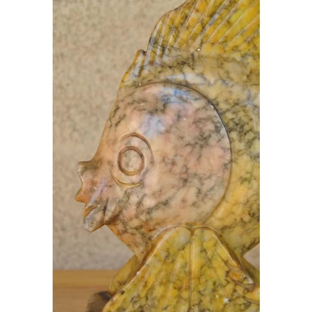 (YOU CAN MAKE REASONABLE OFFERS.) The head of the fish is pink while the rest is yellow. The stone is variegated with dark...