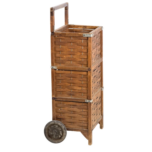 Antique early 20th century hand-crafted rolling utility cart with a hardwood frame, woven wood splint sides, and a solid...