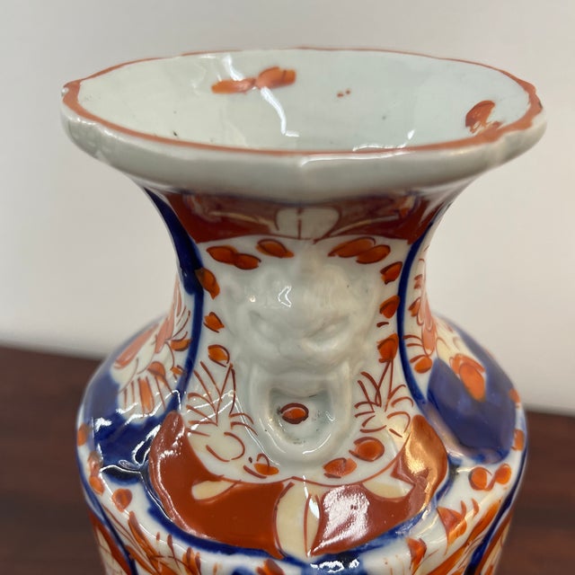 Nice HandPainted late 1800s Japanese Imari vase with lions heads mounded on either side of the neck