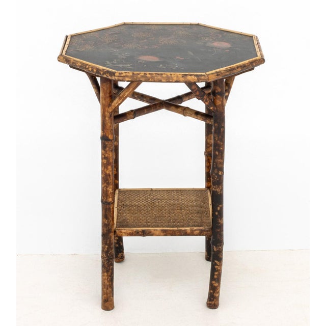 Chinoiserie Lacquered Bamboo Lamp Table, the black lacquer octagonal top with painted floral design, the bamboo frame with...