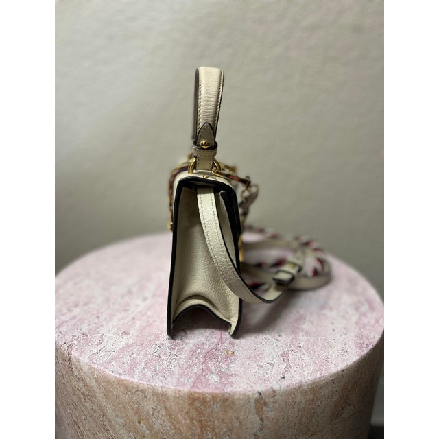 Playful yet unmistakably refined, this Gucci Sylvie Bee & Star Crossbody Bag captures the whimsical spirit and iconic...