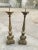 This pair of Italian 19th-century candle holders are made of brass.