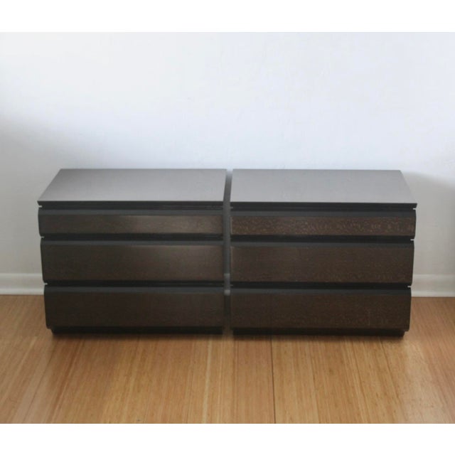 A pair of Giorgio Collection nightstands or end tables with snakewood and black lacquer finish. Each features 3 drawers on...