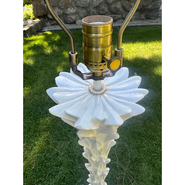 The vintage and iconic Serge Roche style palm tree floor lamp constructed of wood covered in white plaster. The palm tree...