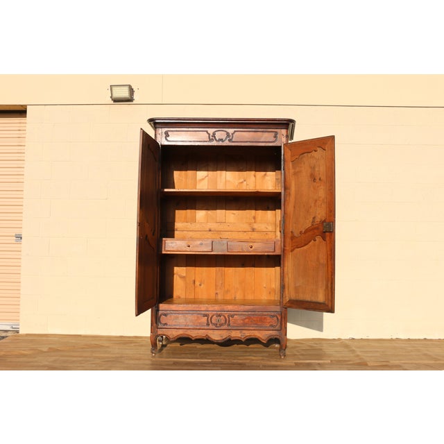 Beautiful antique 19th-century French Provincial armoire crafted from walnut in the Louis XV style. This tall storage...