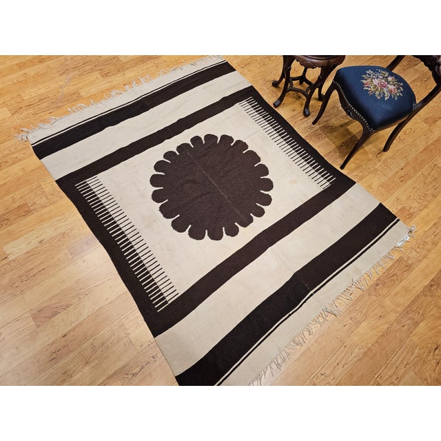 5’ 2” x 6’ 8” Vintage American Southwestern kilim area rug in ivory and brown colors circa the 20th century. The...