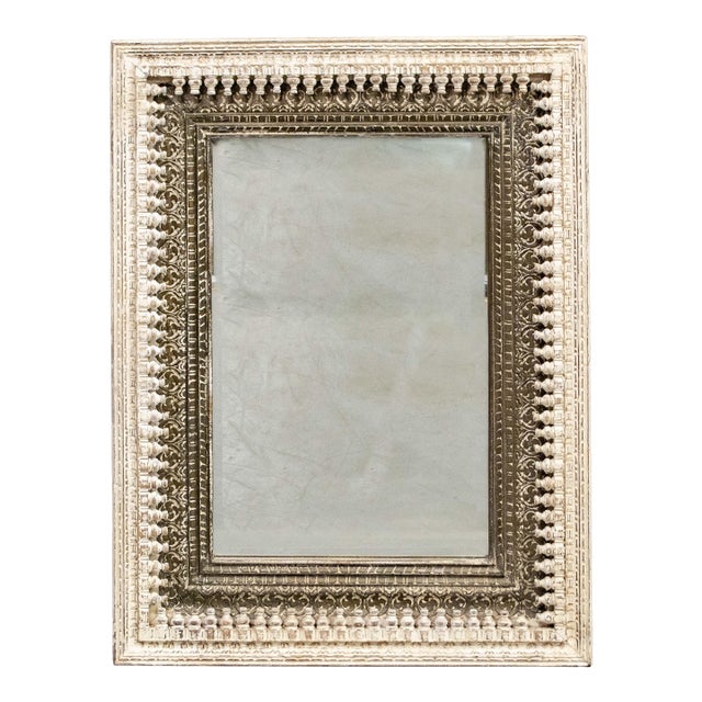 A large carved contemporary mirror frame made from intricately carved moldings with a distressed painted finish. The...