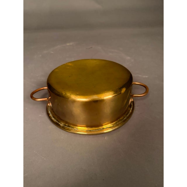 Mid-19th Century French brass cooking pot with copper handles, circa 1850, beautifully handcrafted with a richly aged...