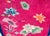 A rare early 20th century oval Art Deco rug with a thin indigo border surrounding a fuchsia field covered in multi-colored...