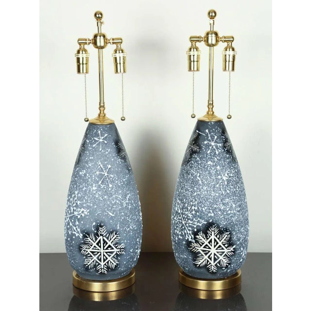 Pair of lovely Italian ceramic lamps with a whimsical snowflake design. The snowflake design is both incised and drip...